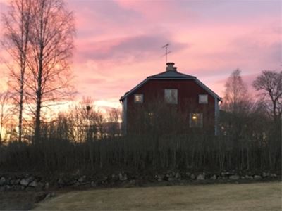 A red building with a sunset.