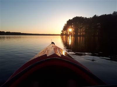 A kayak on the lake in sunset.