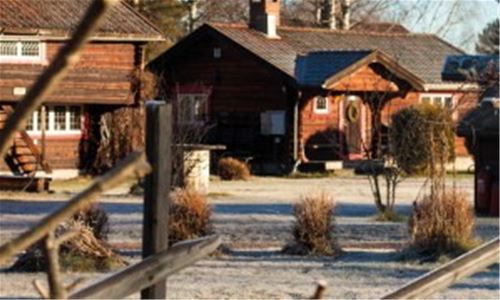 Timber cottages on a frost covered lawn. 