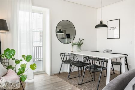 Dining table next to the balcony door. 