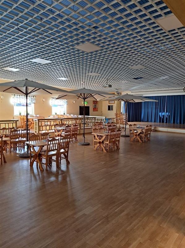 Large hall with table and chairs.