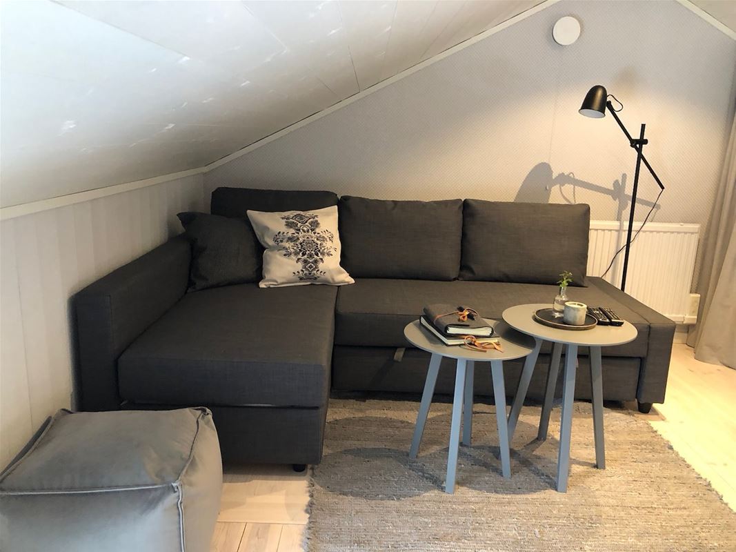 Small corner sofa under sloping roof. 