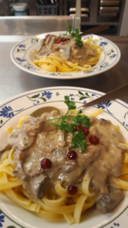 Floral plate with a pasta dish.