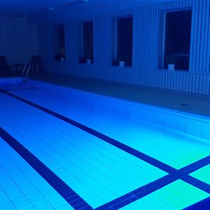 Indoor swimming pool in a blue light. 
