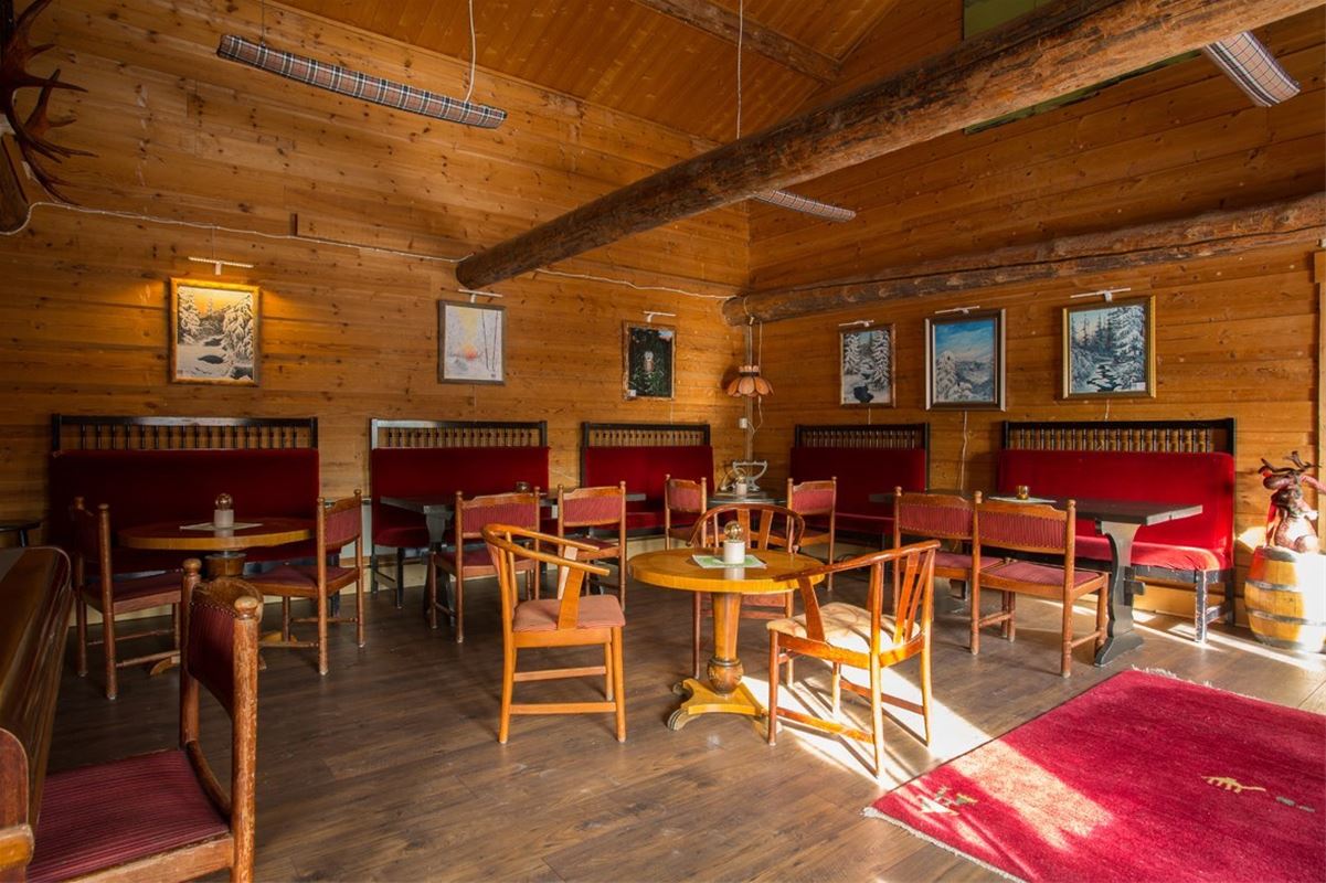 Large room with sofas, chairs and tables. 