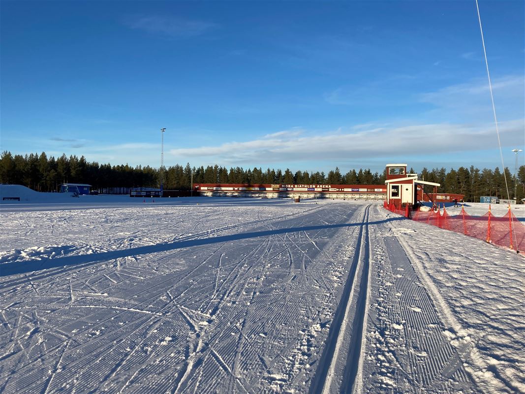 Ski tracks with barracks in the background.