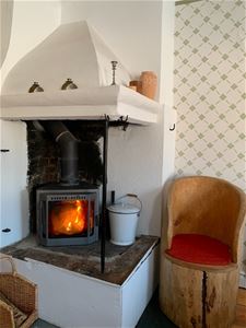 Fireplace, wooden chair.