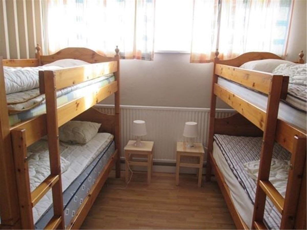 Two bunkbeds on each side of the window.