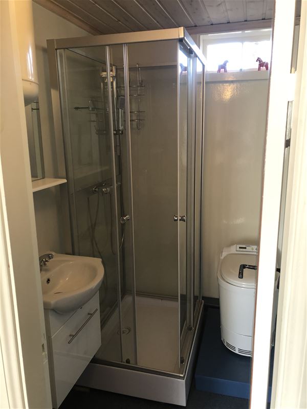 Bathroom with sink, combustion toilet, shower cubicle.