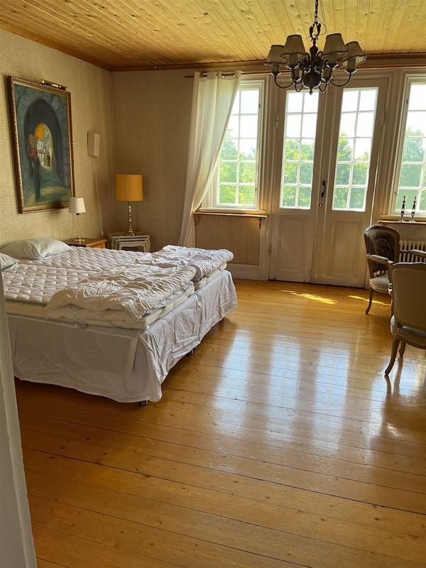 Room with doublebed and large windows. 
