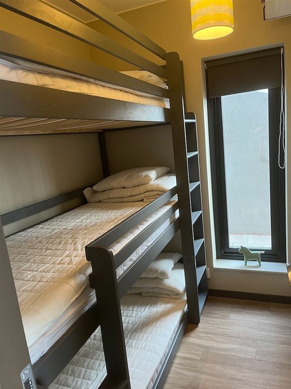 A bunk bed with three beds.