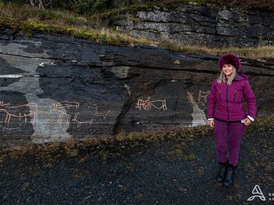 Guest in front of rock carvings