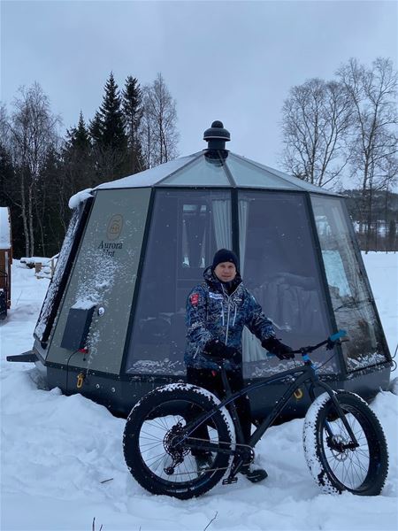 North Experience,  &copy; North Experience, A man with a fatbike outside one of the glass iglos at North Experience 
