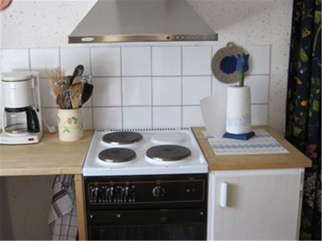 A stove with own in the kitchen.
