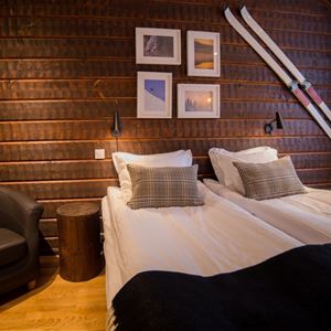 Bed at a timbered wall. 