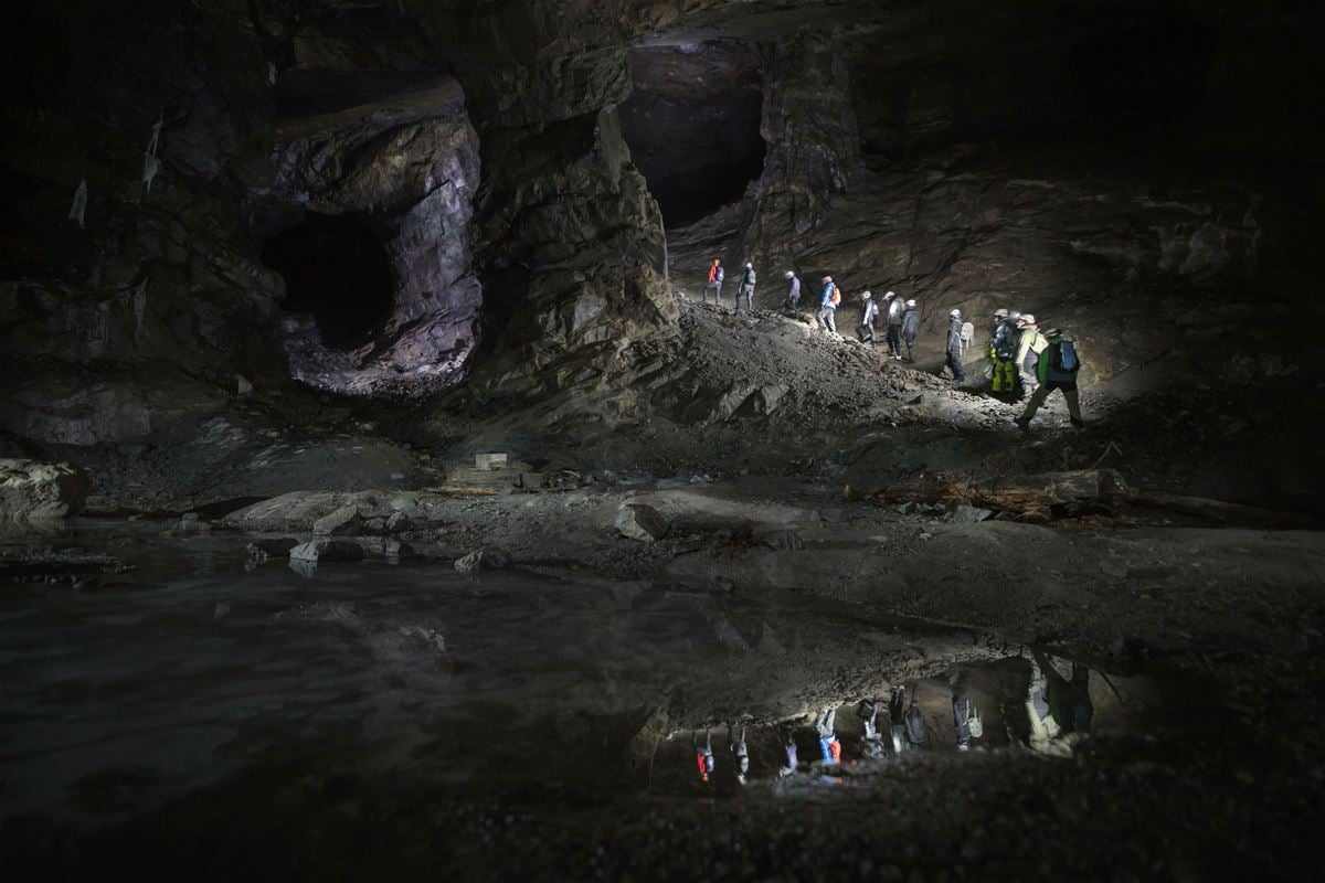 People lined up in the darkness of the mine.