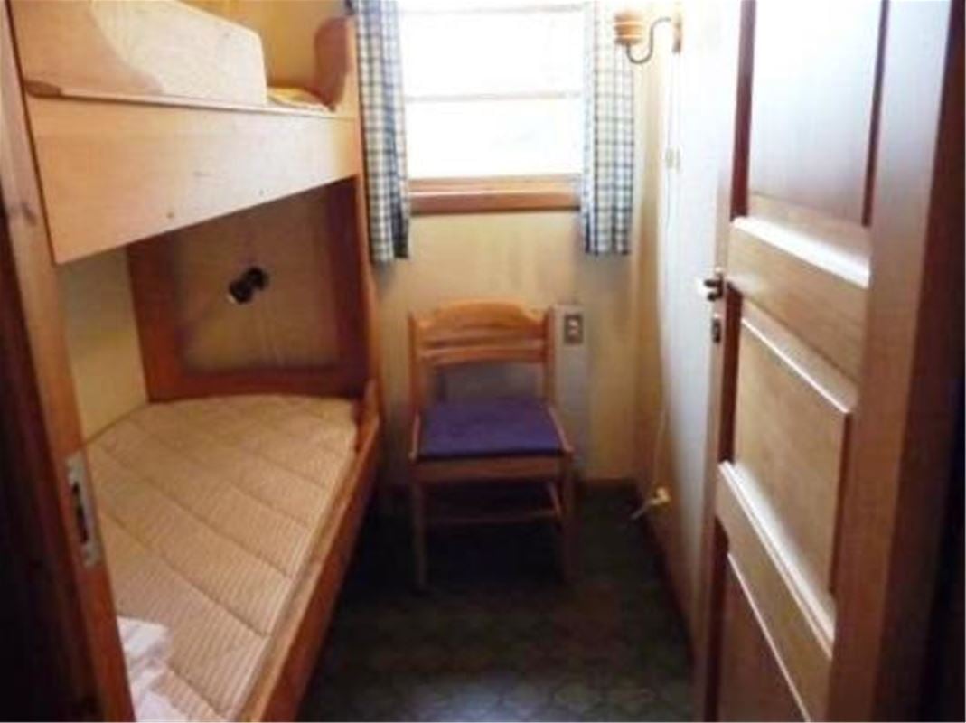 A small bedroom with a bunk bed.