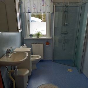 Badrum med wc, dusch och handfat.