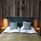 A bed with pillows and a headboard in a room with wood paneling.