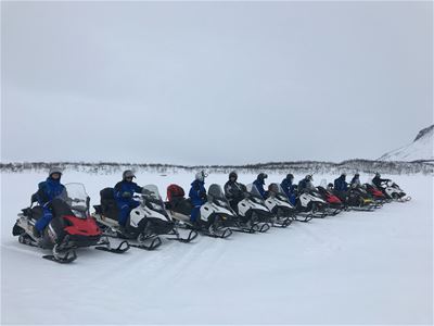 Guests drive the snow scooters side-by-side