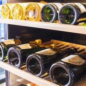 A shelf with wine bottles.