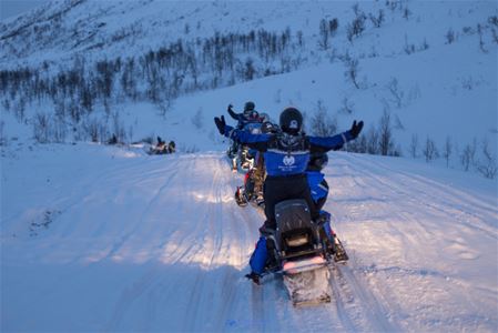 Snow scooter drivers enjoying themselves at Camp Tamok
