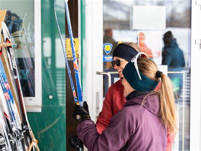 People holding skis