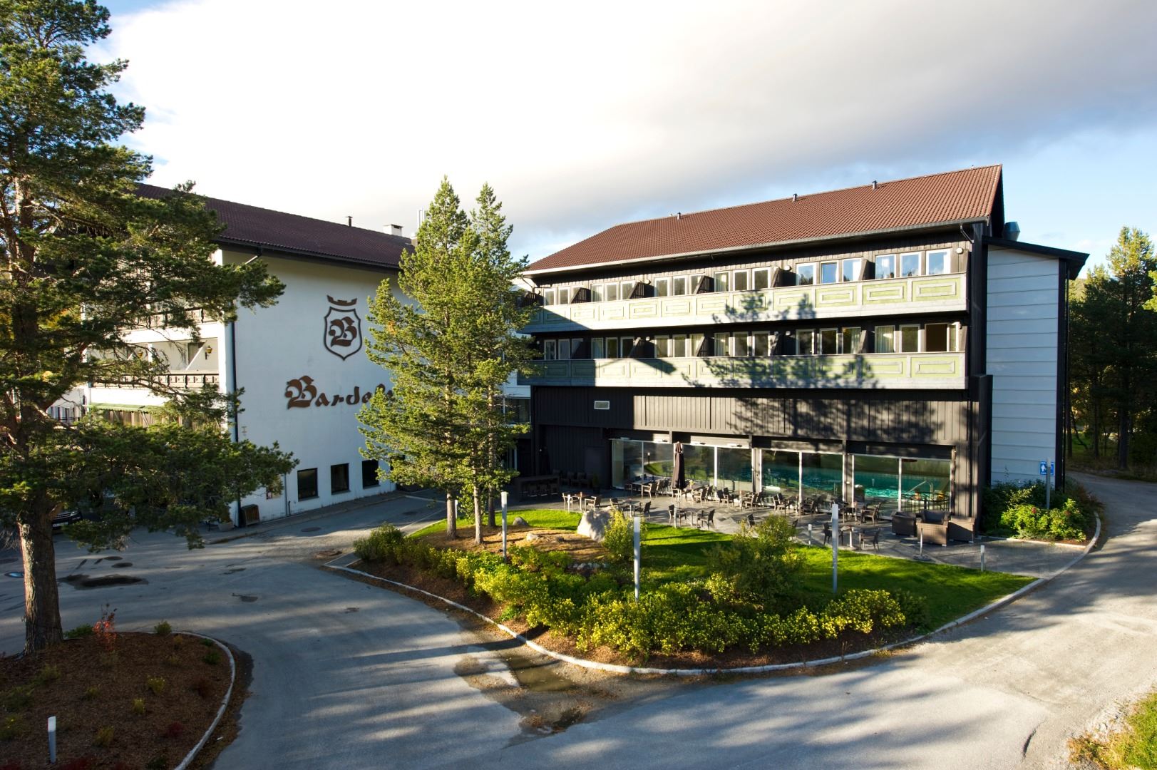 A building with a lawn and trees.