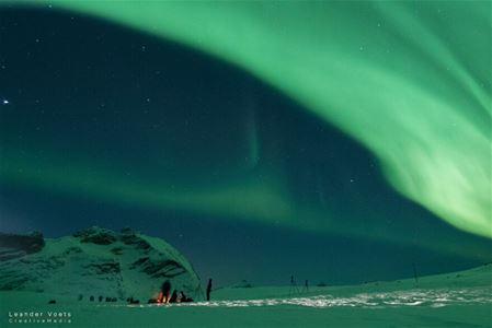 Northern lights above Arctic winter landscape in the Tromso region