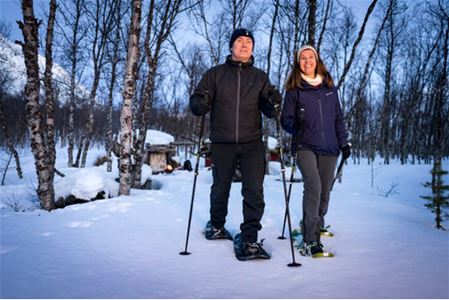 Guests walk in the snow with snow shoes